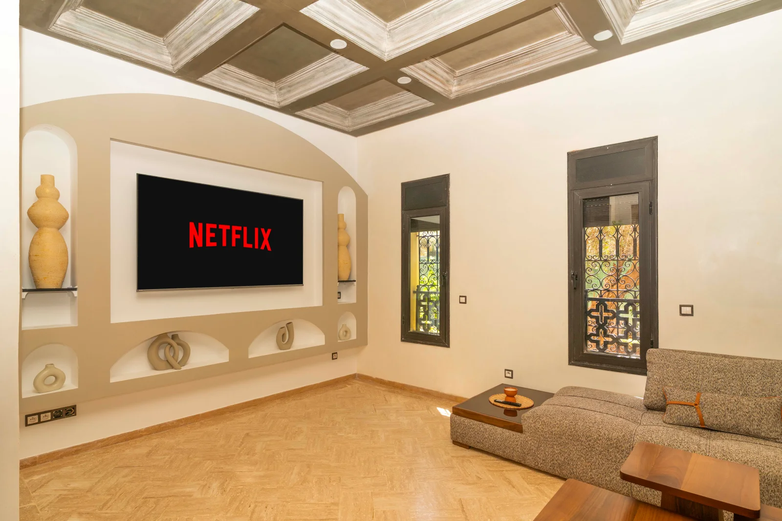 Main living room with a large wall-mounted TV and sofa