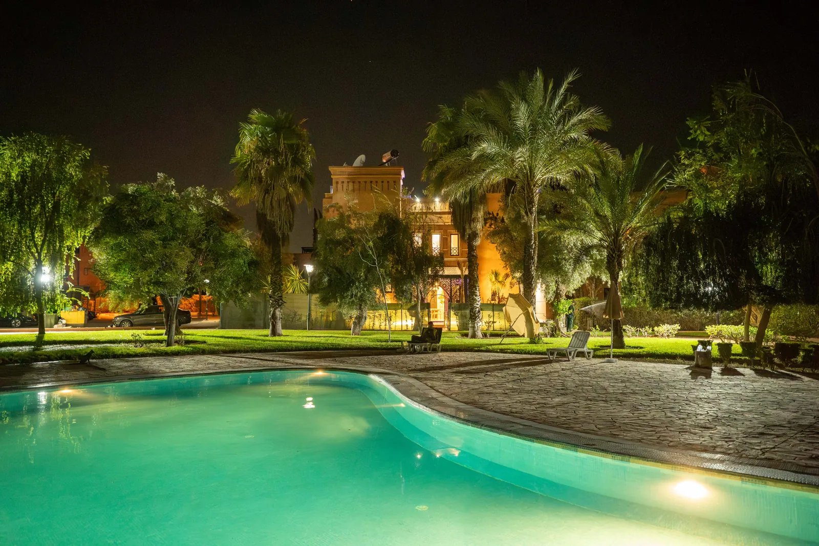 Residence garden and shared pool at night